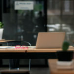 dark-tone-office-workplace-wooden-work-desk-with-laptop-documents-modern-interior-cozy-cabinet-